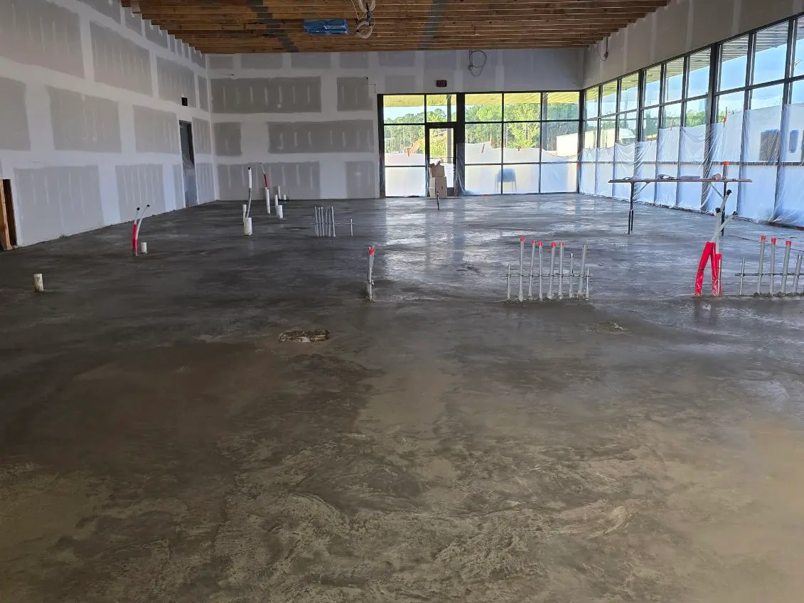New commercial concrete floor poured around plumbing rough-in by OTM Concrete