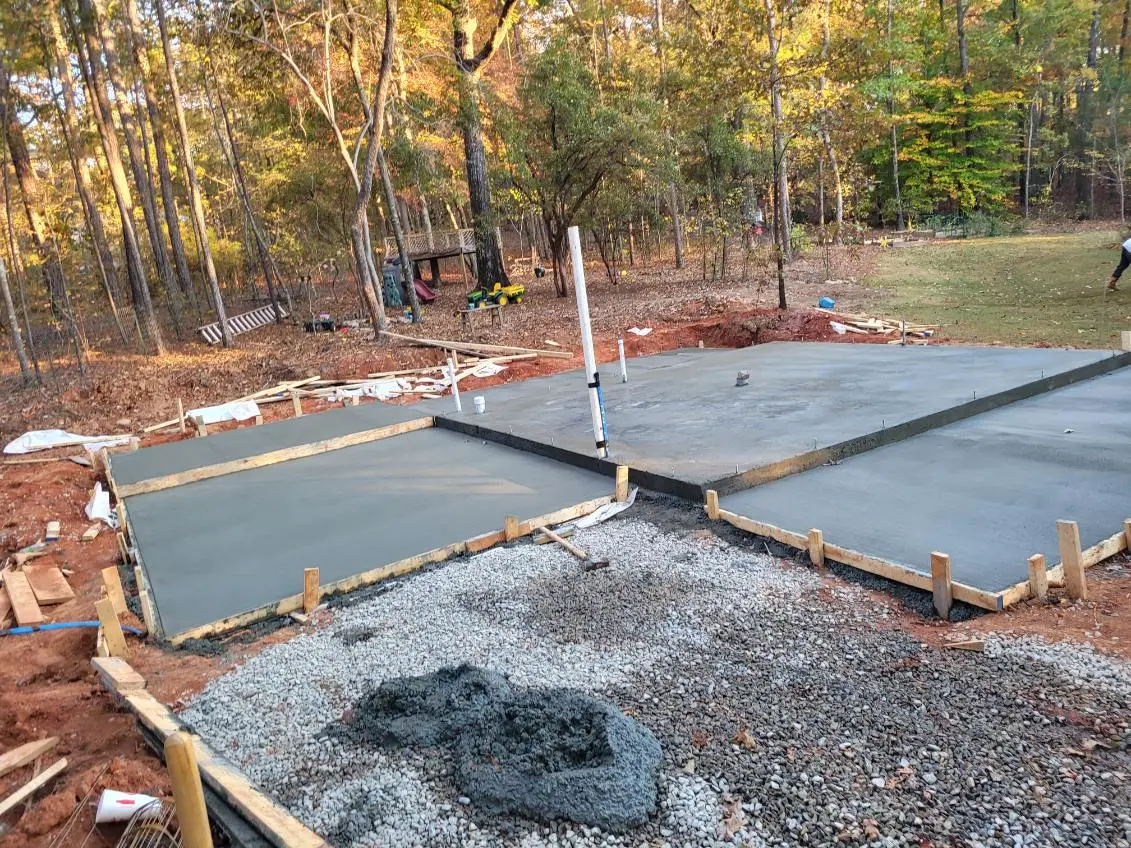 Plain grey poured concrete patio with a broom finish by OTM Concrete