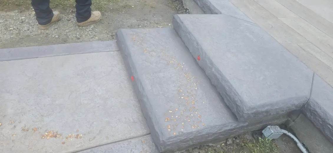 Stamped concrete overlay on steps and a front walkway by OTM Concrete