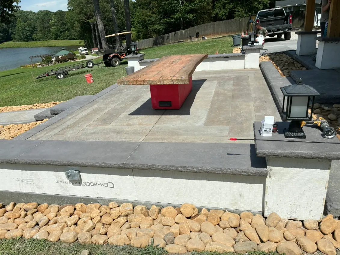 Outdoor living build with a stamped concrete patio, bar and seating walls by OTM Concrete