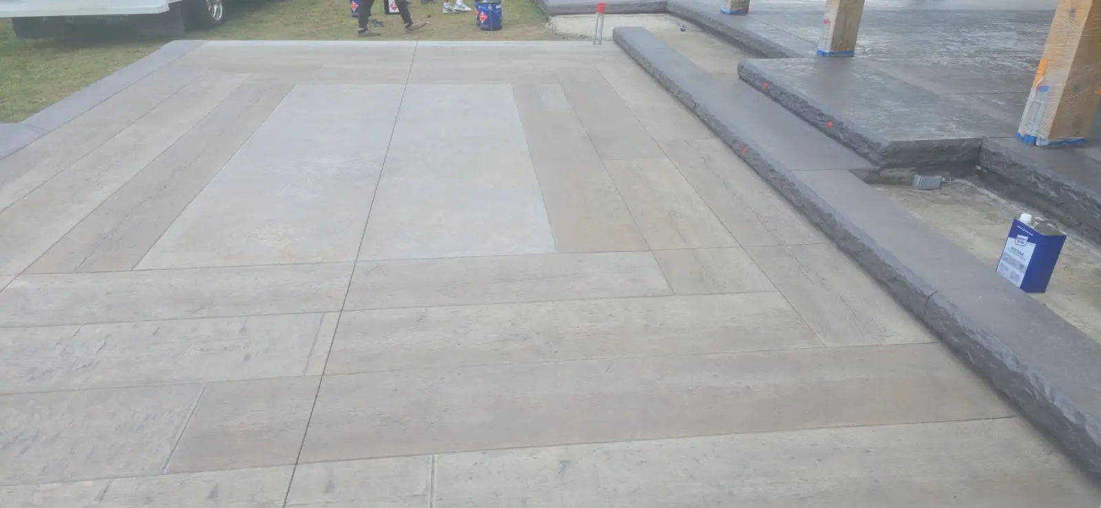 Stamped concrete patio with plank borders installed by OTM Concrete