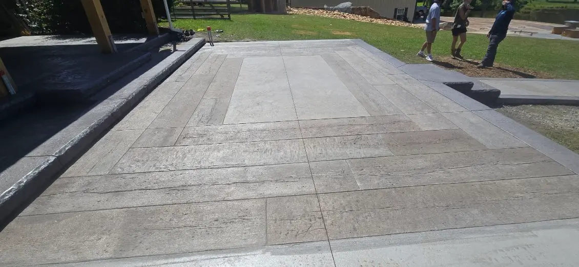 Wood-textured stamped concrete patio design by OTM Concrete