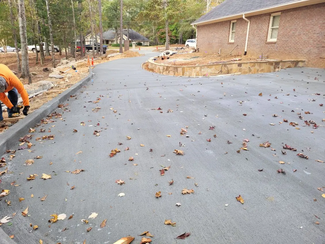 Freshly poured plain grey concrete driveway installation by OTM Concrete
