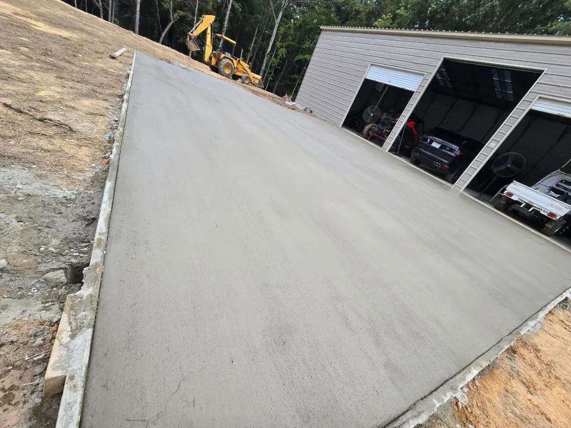 Newly poured traditional grey concrete driveway by OTM Concrete